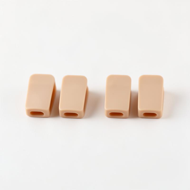 Set of four silicone cable management clips in champagne